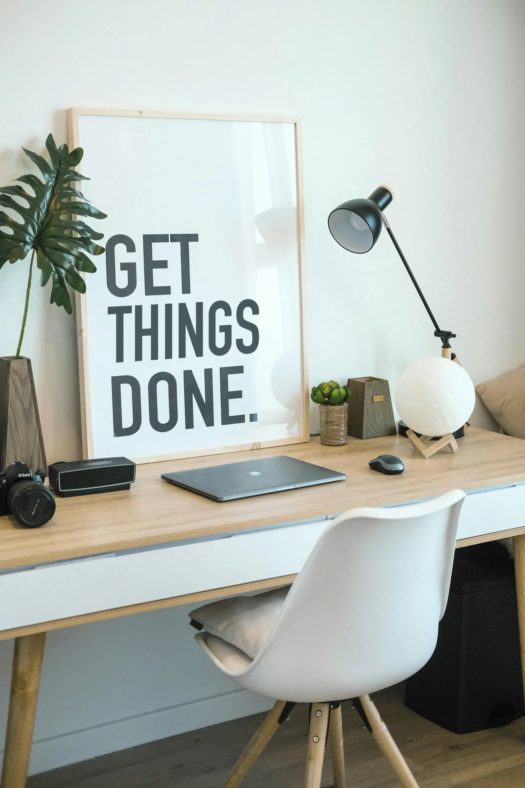 desk with laptop and poster